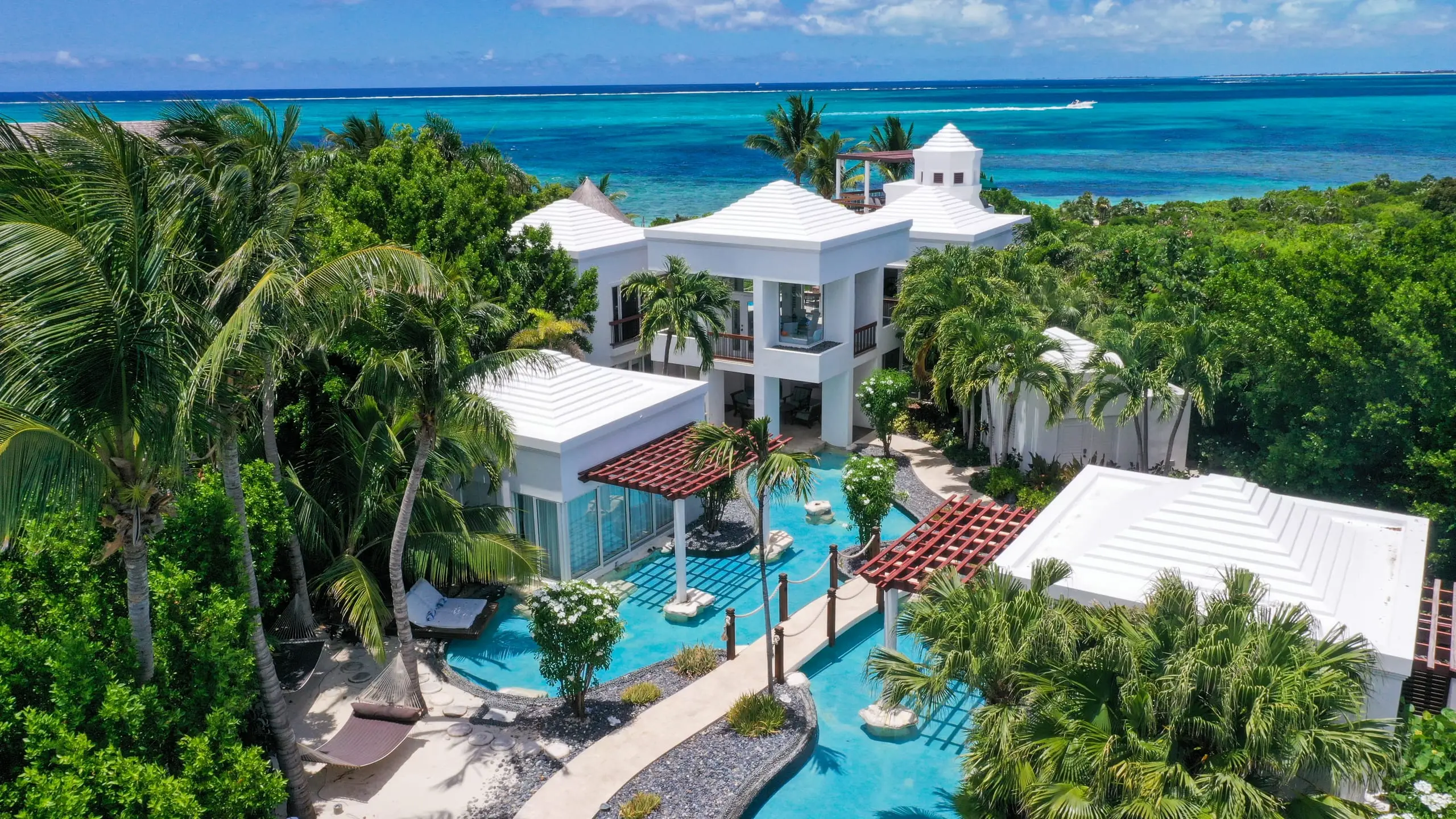 The villa, its pools and the ocean from above