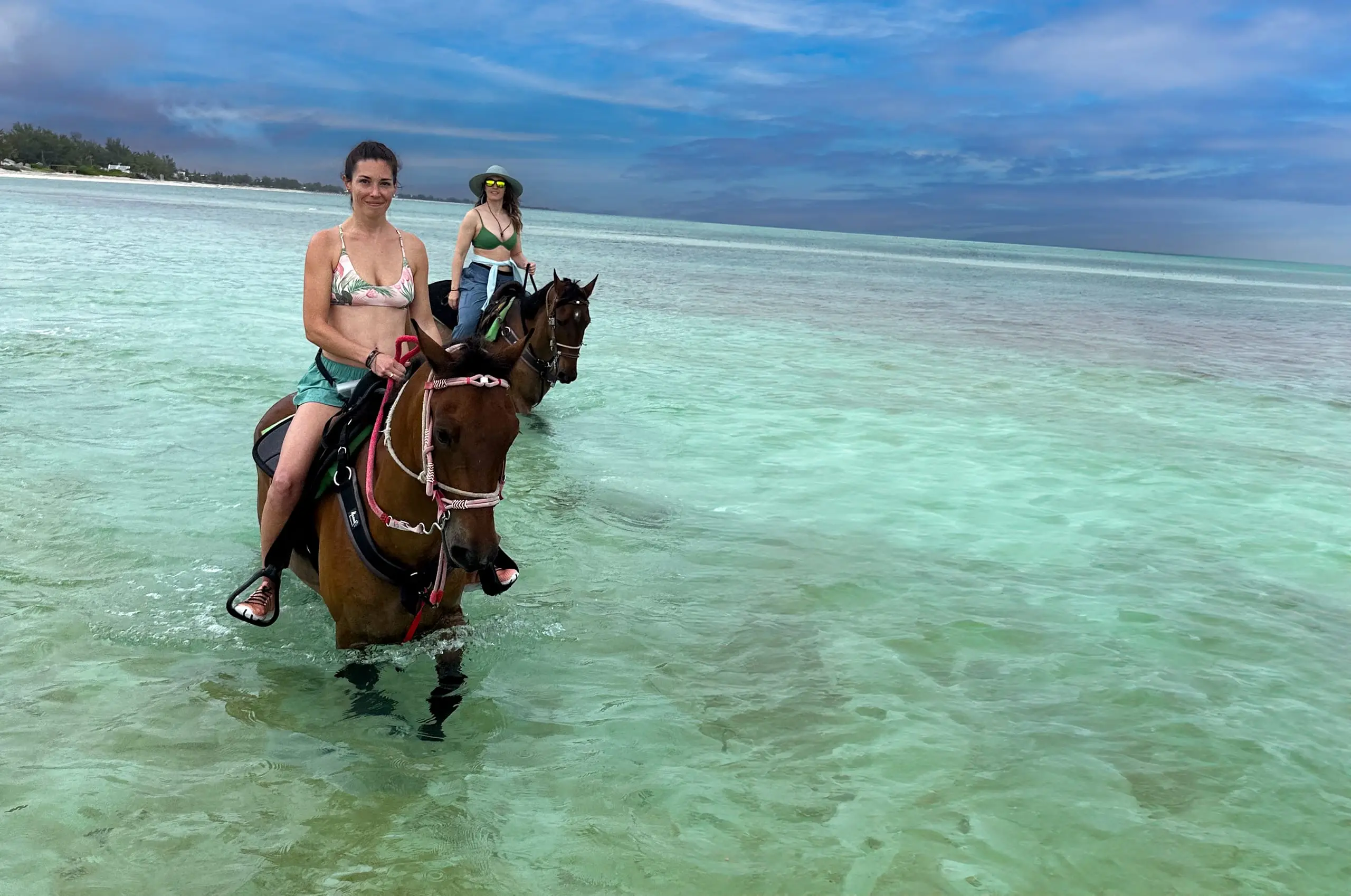 Horseback riding through the turquoise shallows