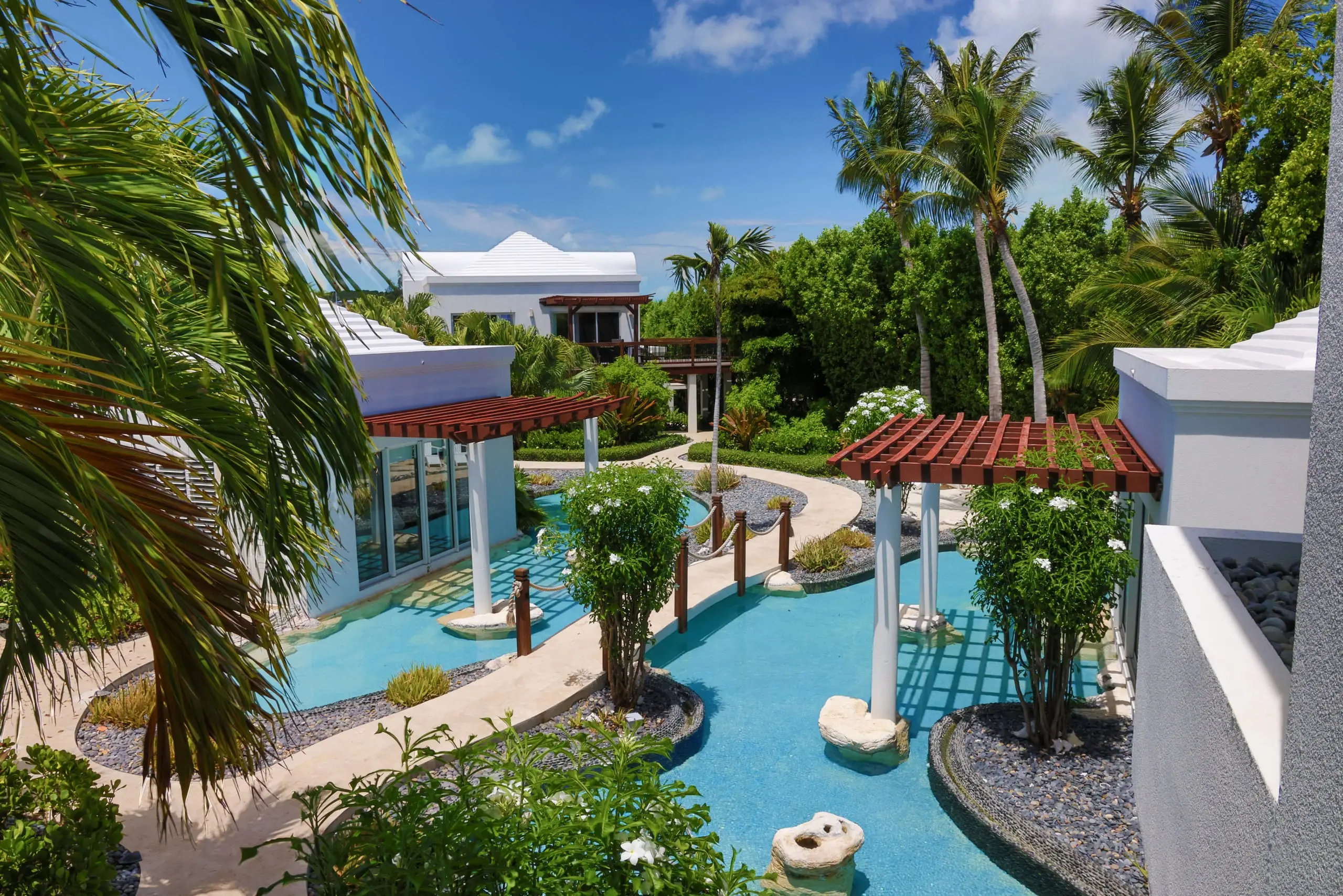Pergolas and palms along the lagoon pool