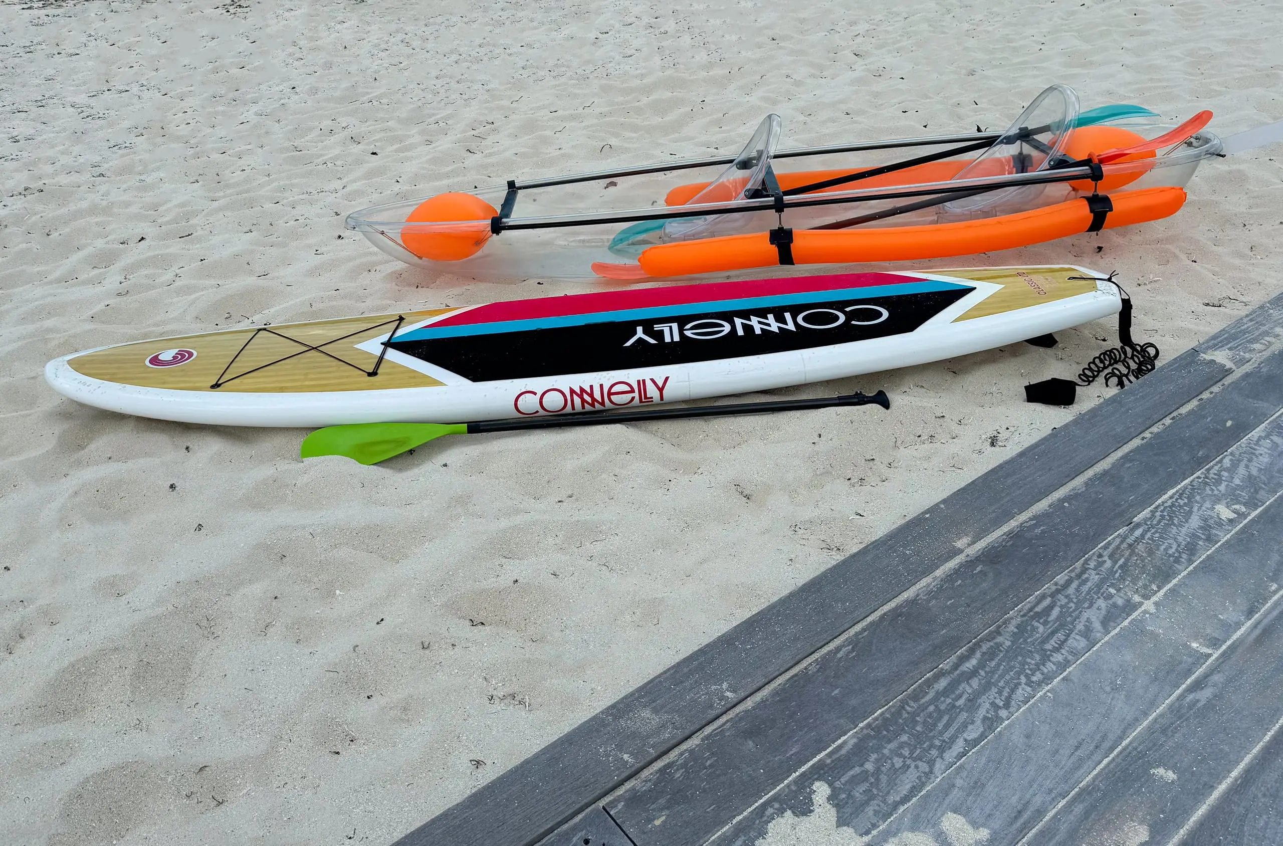 Paddleboards and kayaks on the sand
