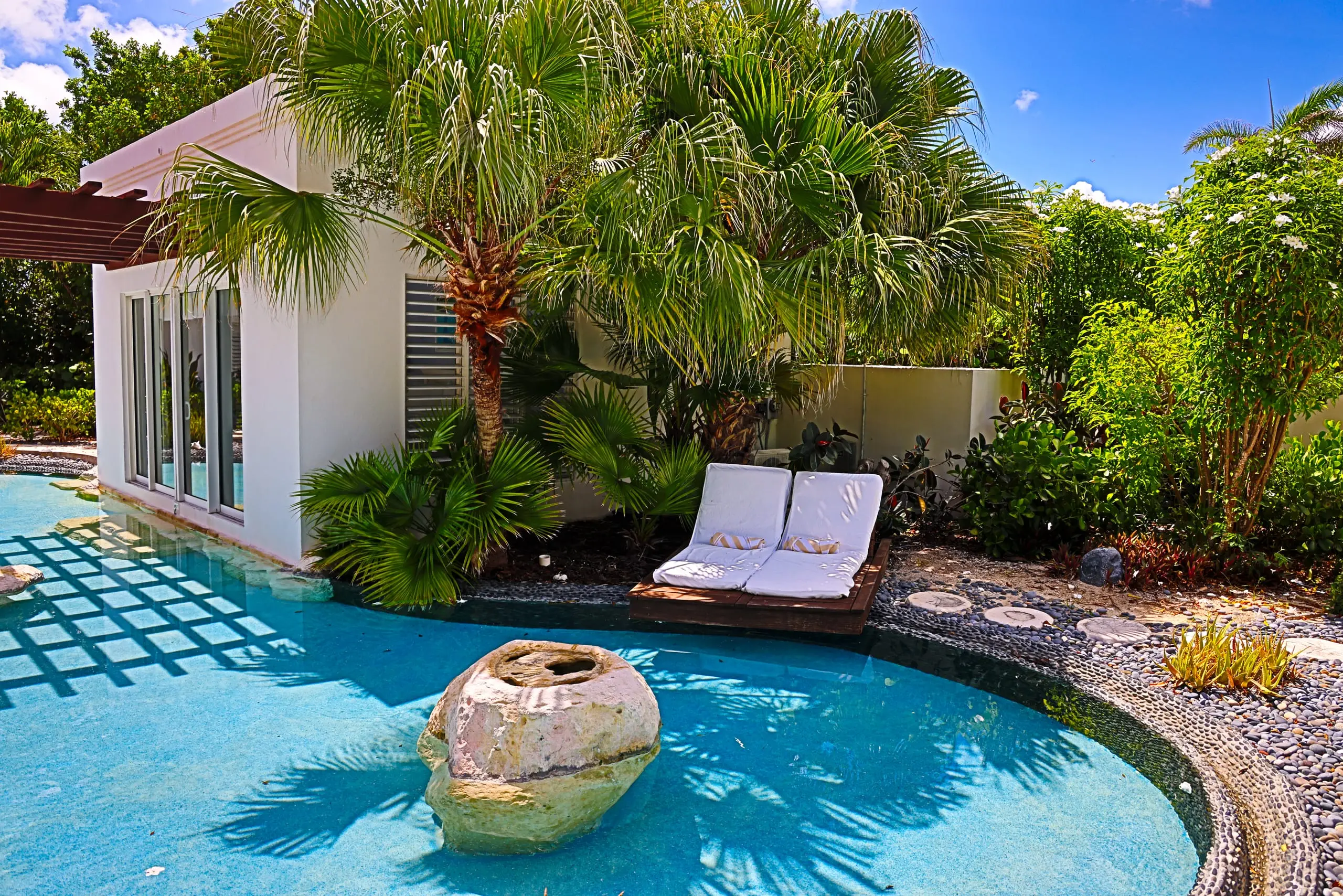 Suite Four’s daybed beside the lagoon pool